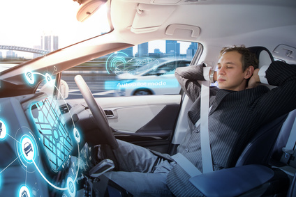 Caucasian man riding autonomous car. Self driving vehicle. Driverless car.